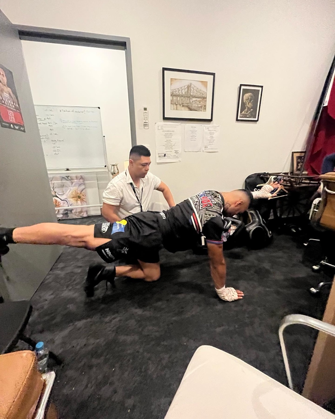 Gary Chen preparing champion Leti Leti backstage before a bout