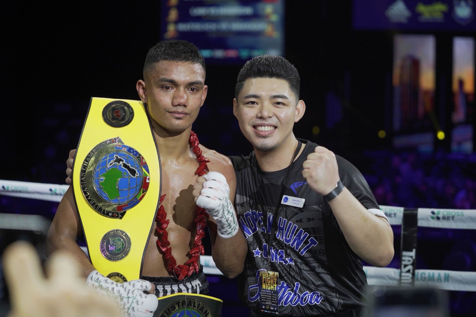 Gary Chen in the ring beside Australasian champion Andrew Hunt as he holds the title belt