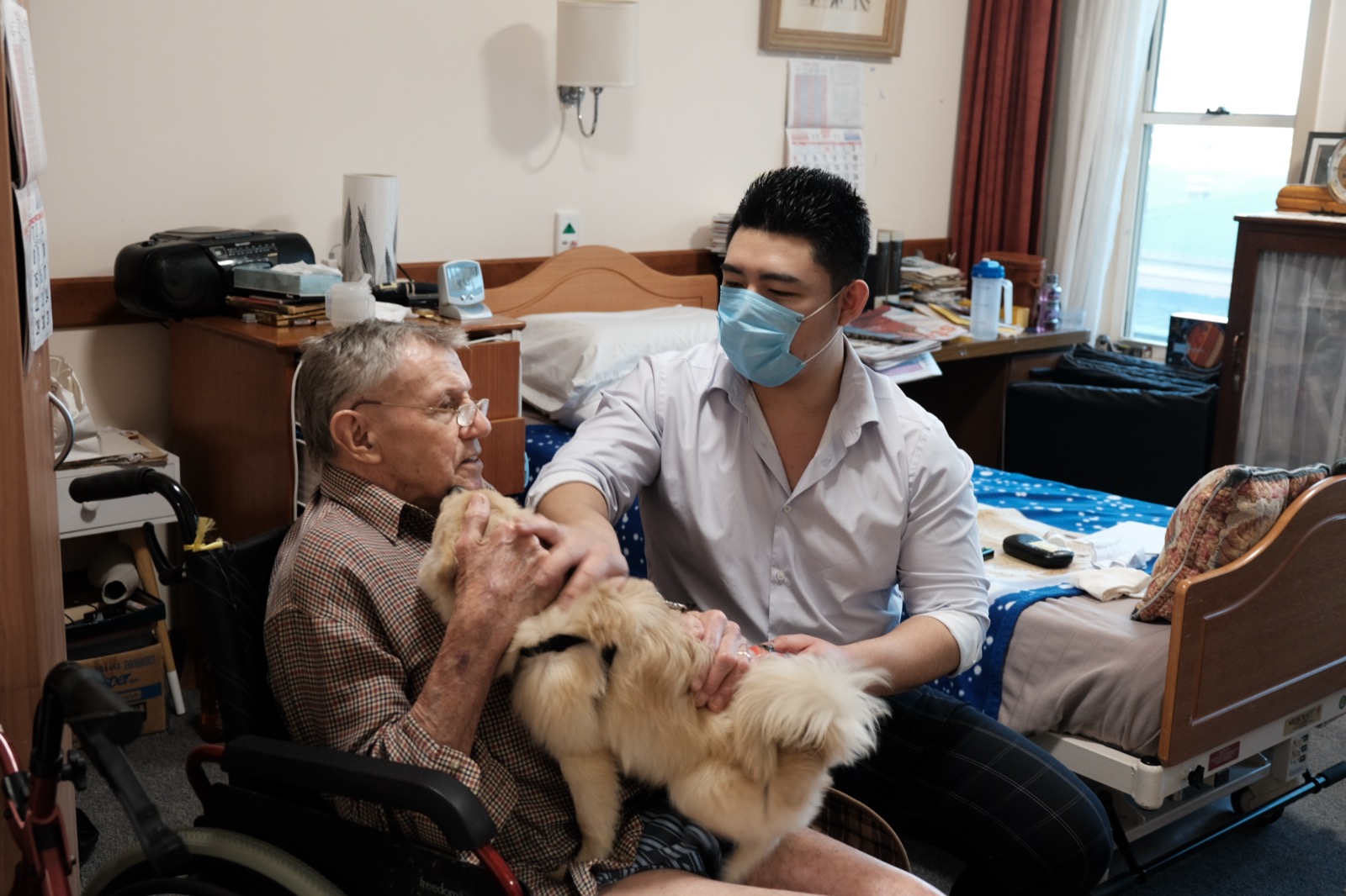 Gary Chen at the bedside with an older patient, present and attentive