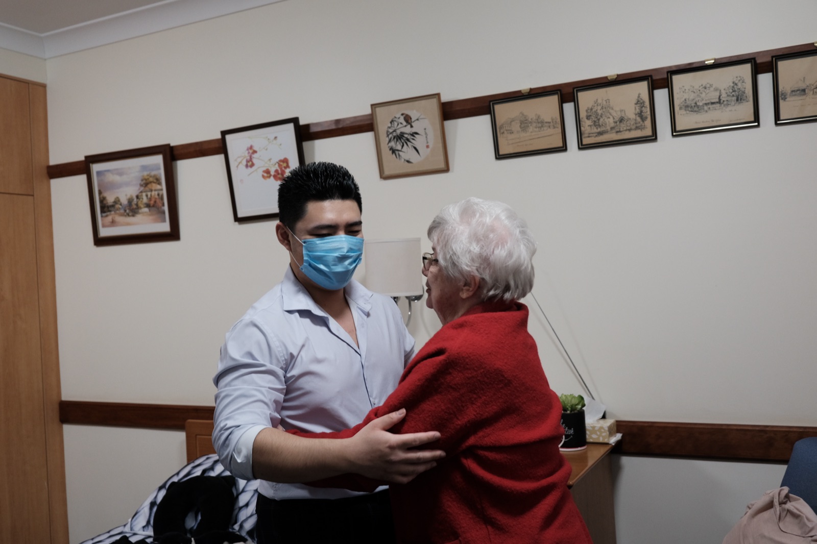 Gary Chen greeting an older client with warmth in an aged-care setting