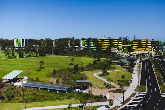 Aerial view across Village Heart parkland, paths, Village Boulevard and precinct buildings